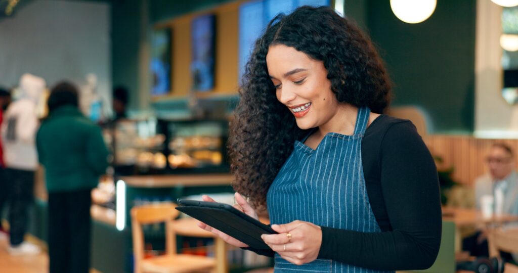 Cafe, woman and business owner on tablet for restaurant sales, online profit or e commerce inventor