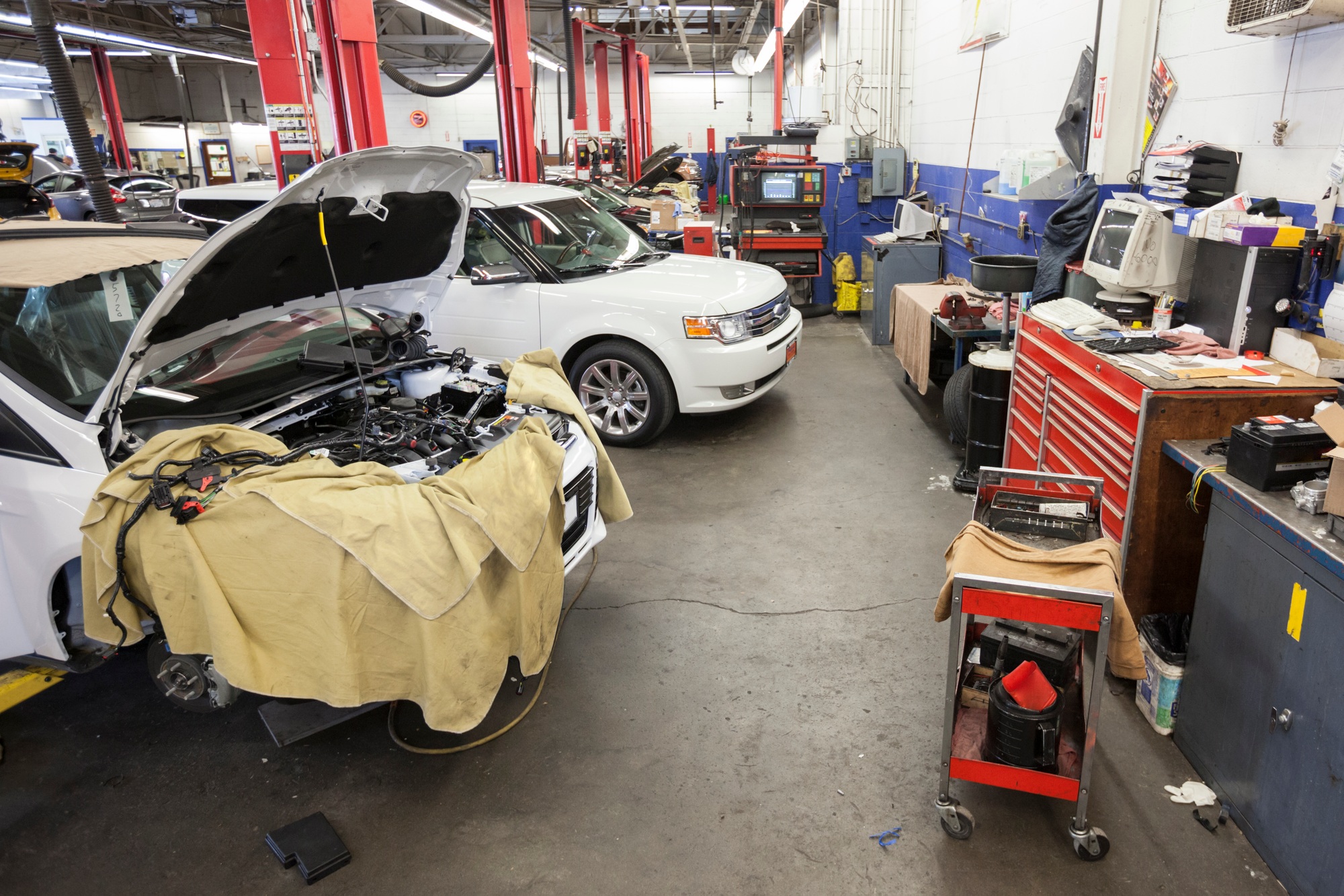 Cars and machinery in an auto repair shop.