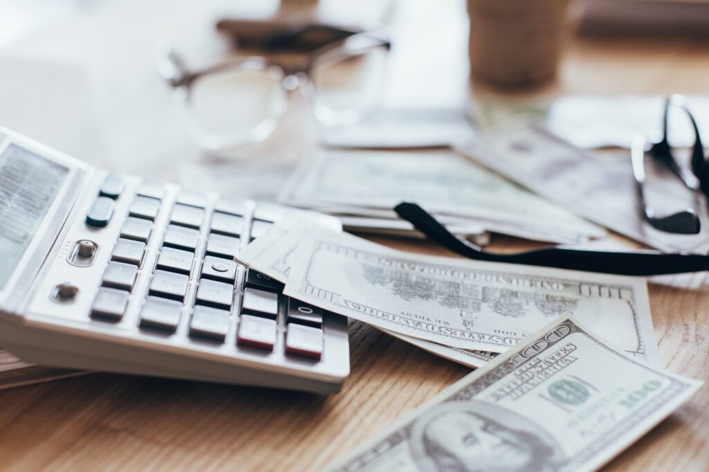 close up view of money and calculator lying at workplace